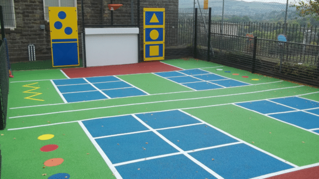 School playground with different coloured tarmac on the floor and games printed on top