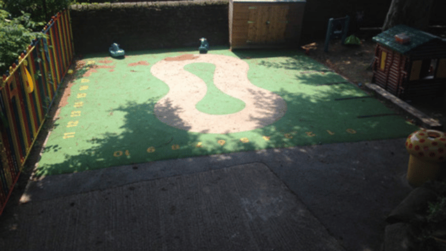 Green playground flooring with cream design in the middle
